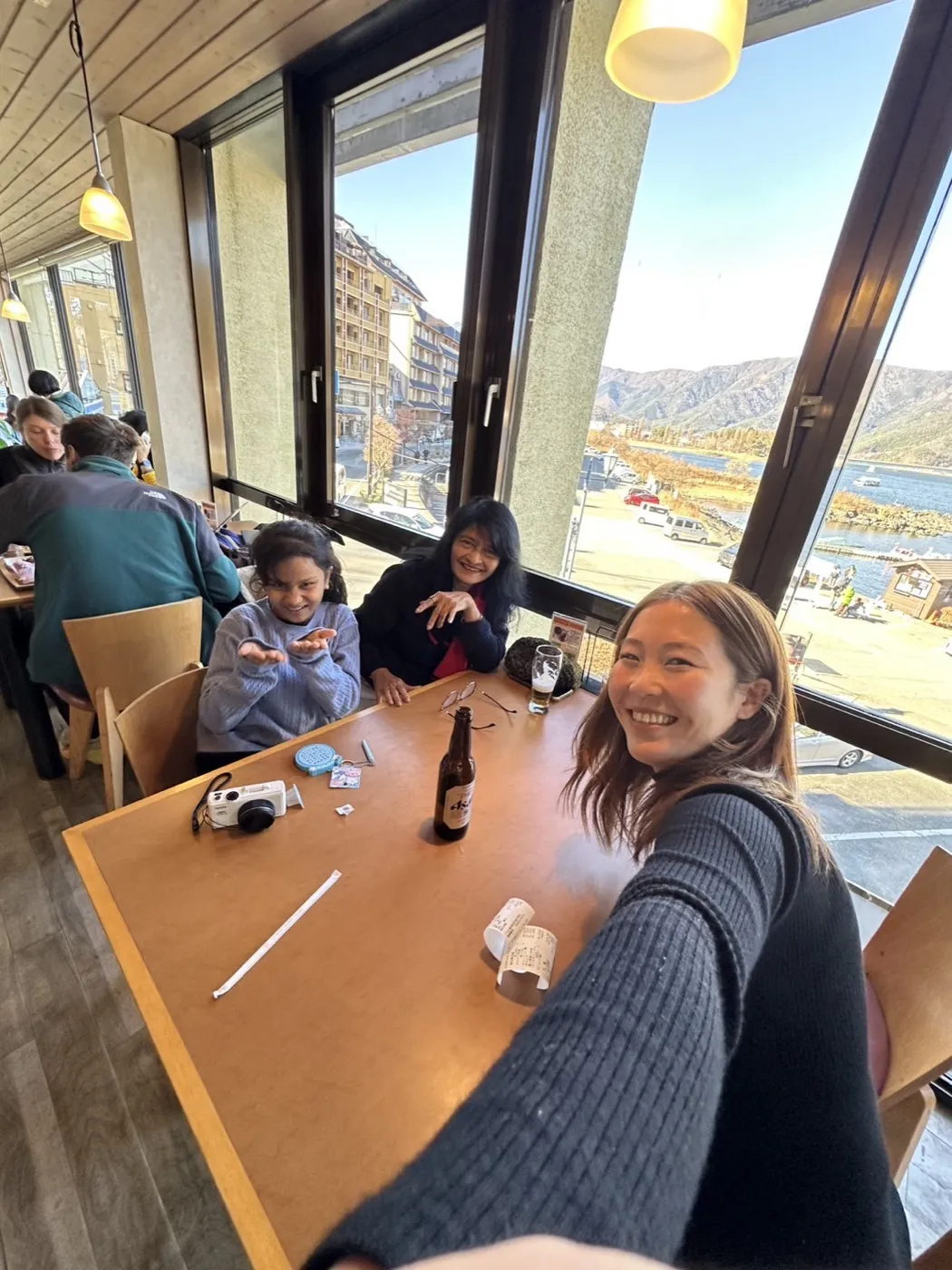 Guests at lunch in a restaurant with large windows looking out over a lake near Mt. Fuji