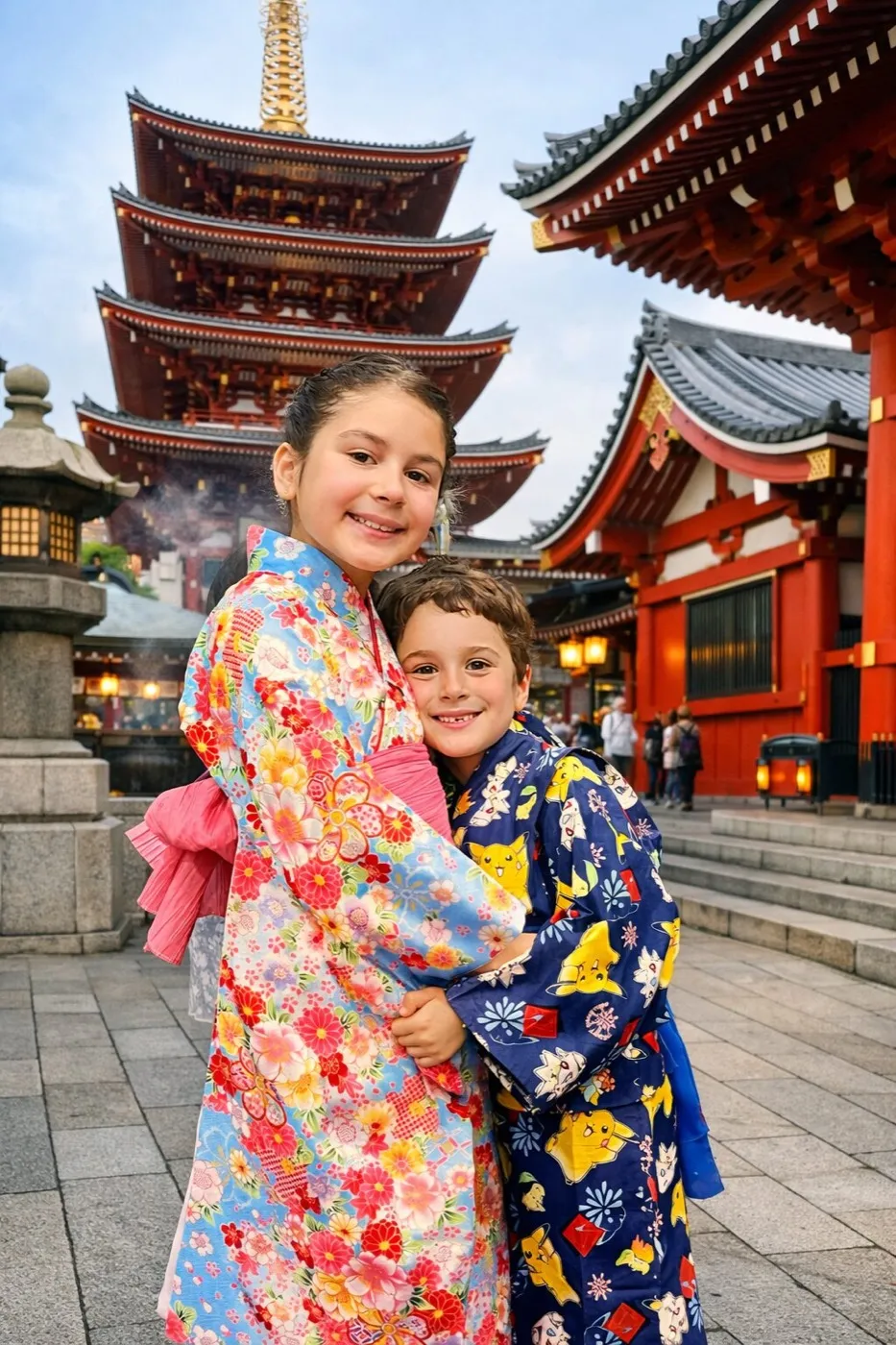 Two children in kimono hugging in front of the five-storey pagoda at Senso-ji