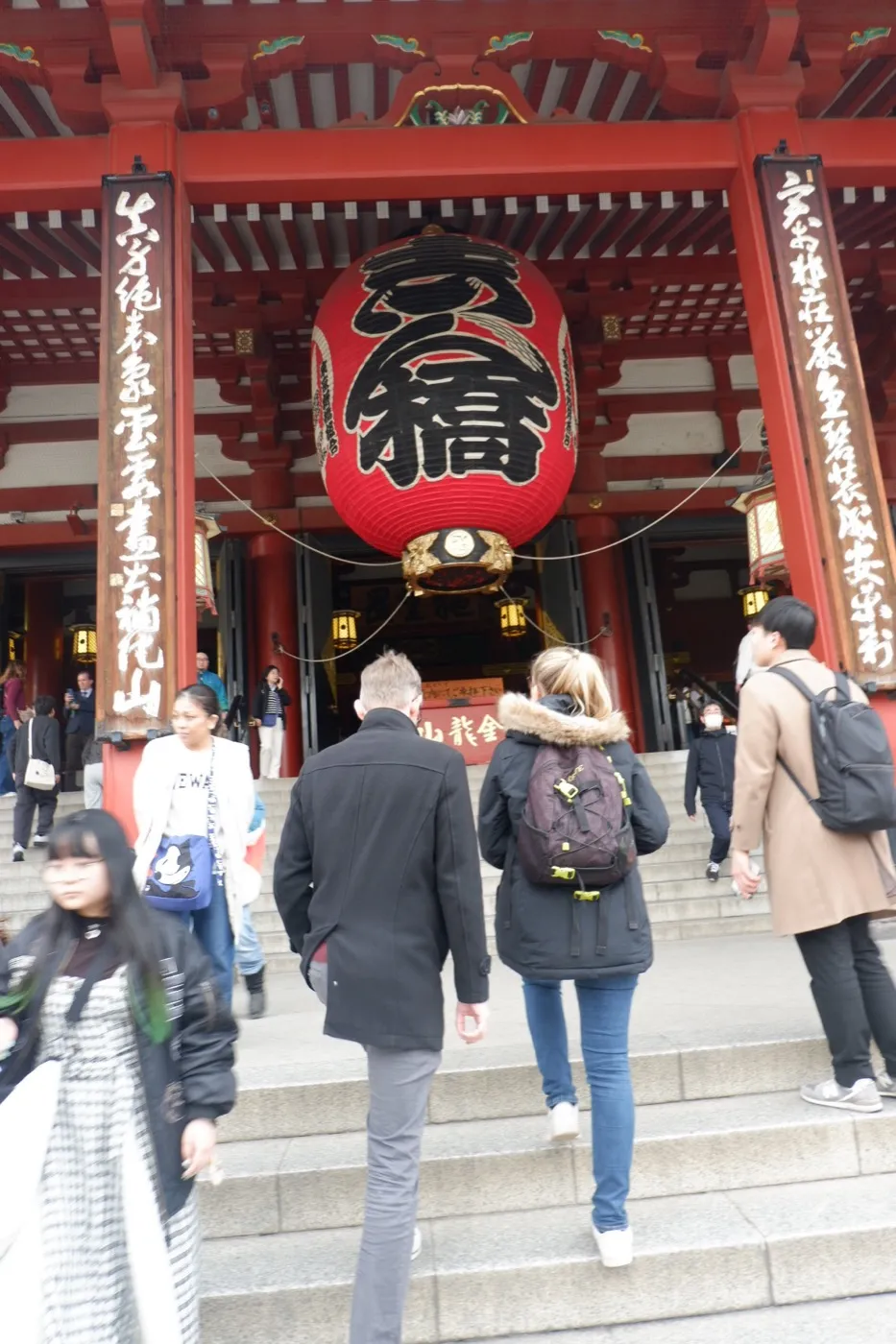 The main hall of Senso-ji temple in Asakusa with its large red lantern and visitors on the steps
